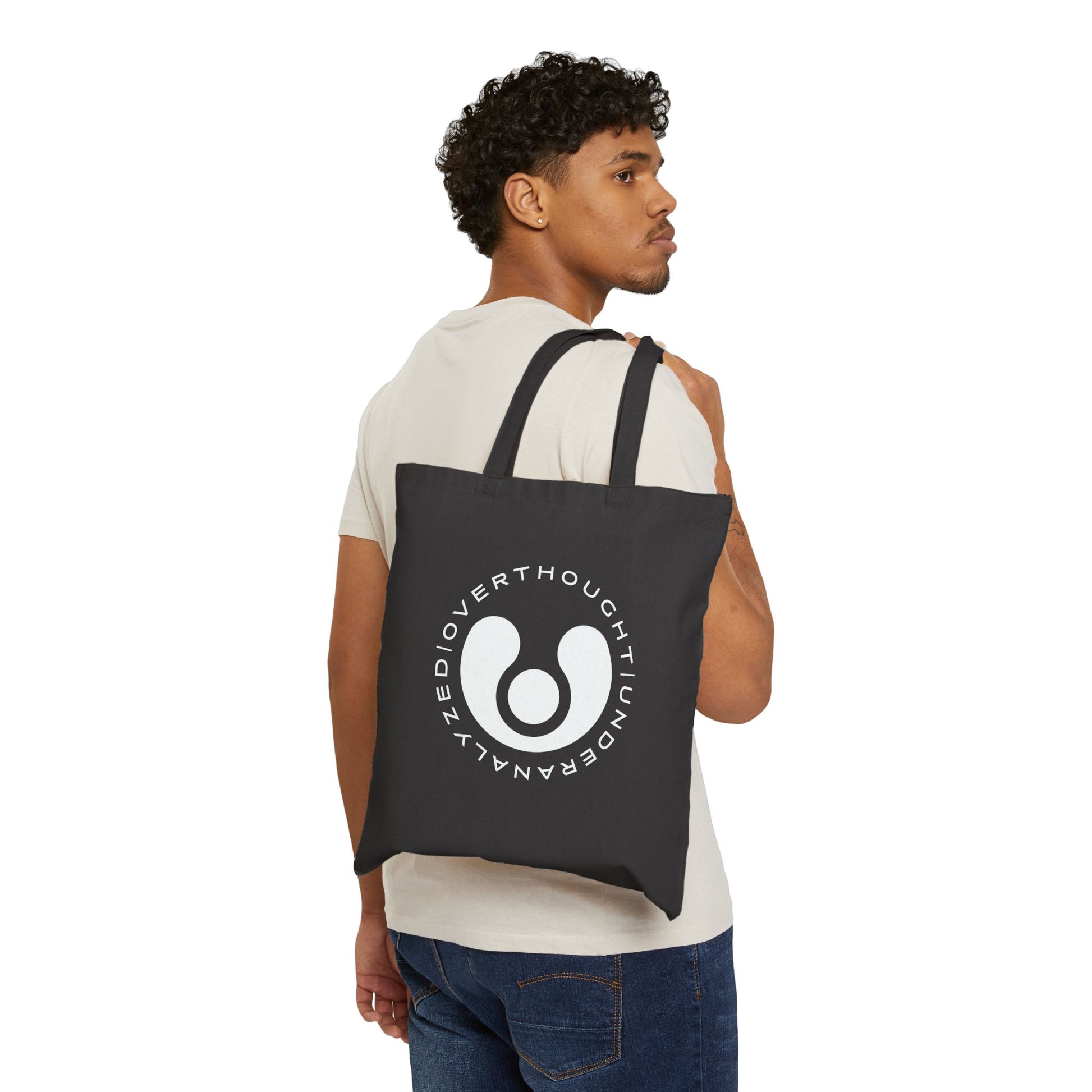 black cotton tote bag with a circular logo and graphic design on the front.