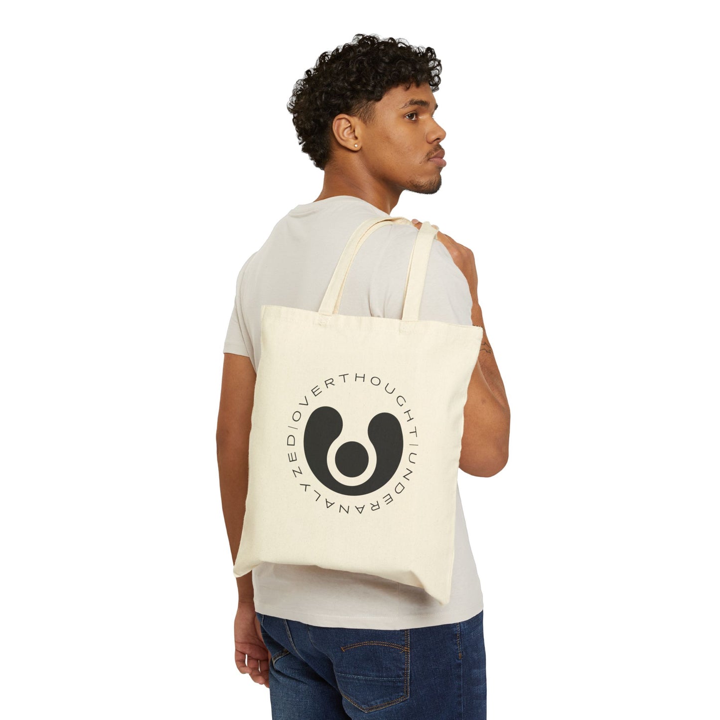 white cotton tote bag with a circular logo and graphic design on the front.