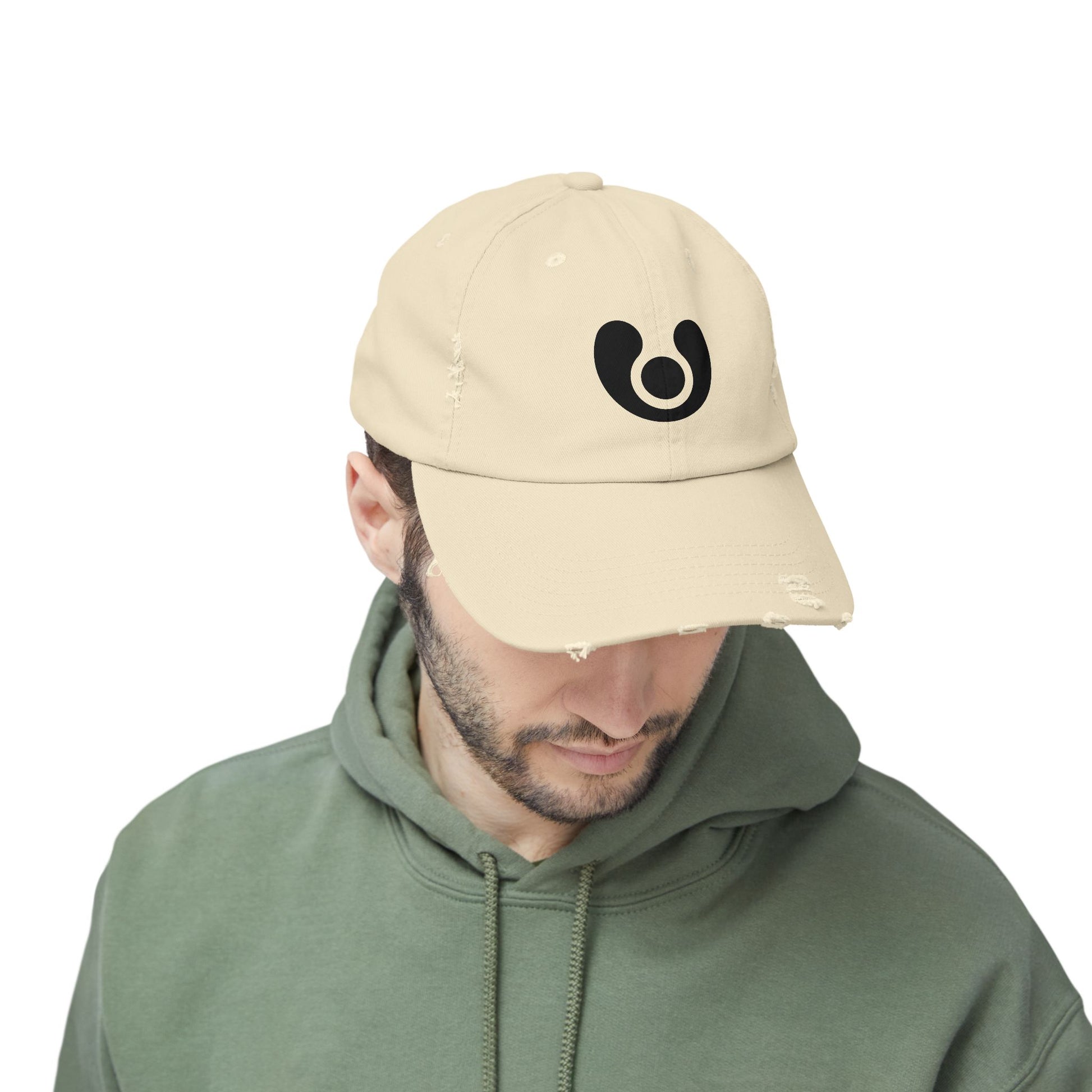 Person wearing a beige cap with a logo 