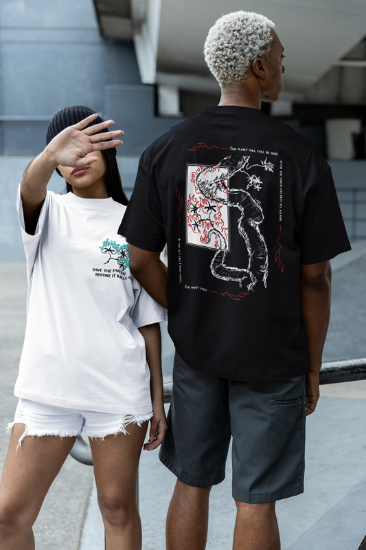 Two people wearing graphic t-shirts with designs, one white and one black, standing on a street.