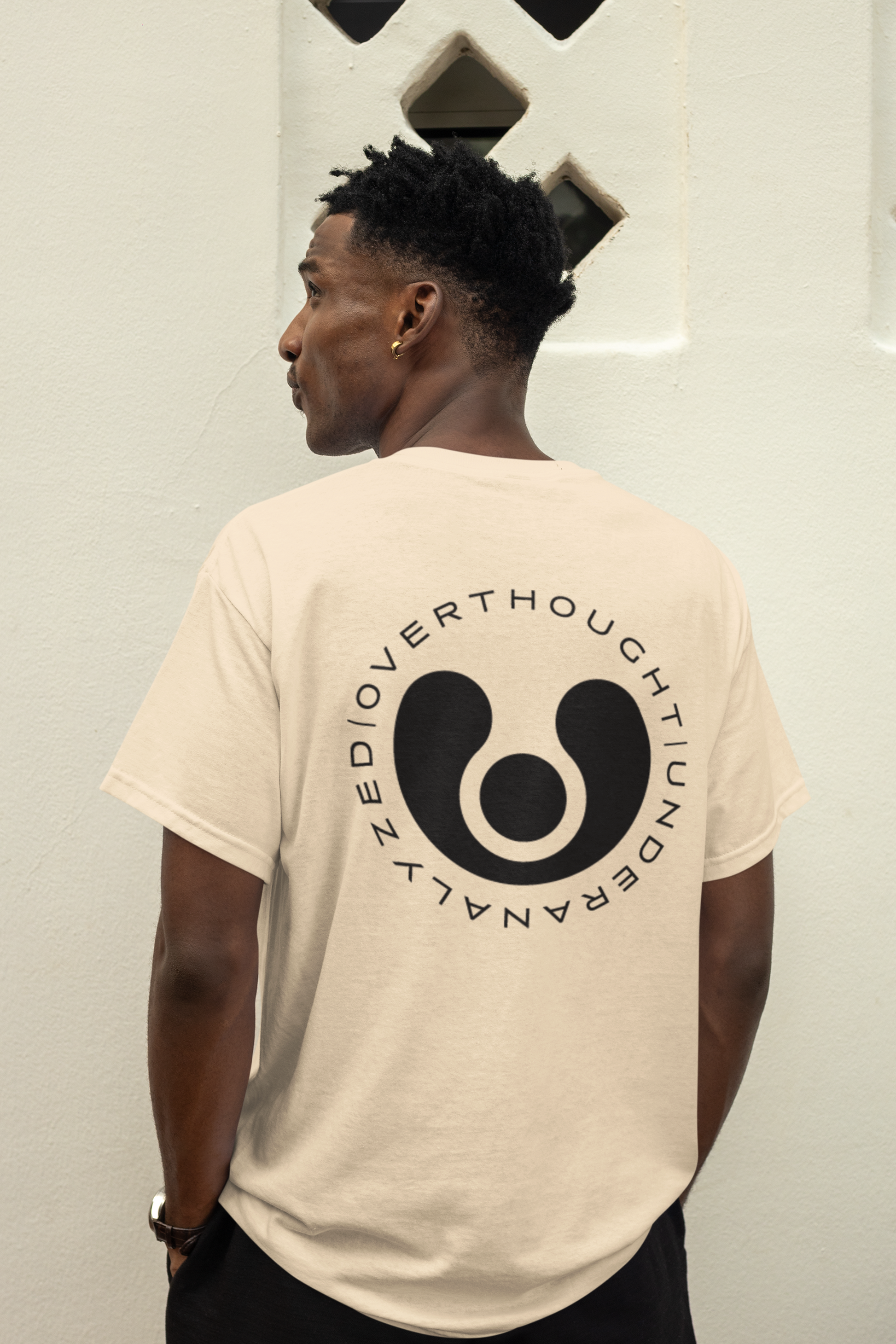 beige t-shirt with a black logo and text on the back